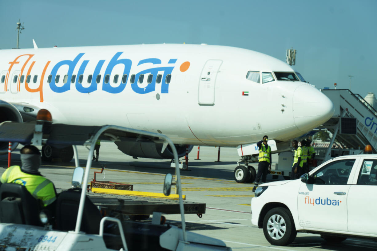 Workers prepare a FlyDubai flight at Dubai International Airport in Dubai, United Arab Emirates, Friday, Oct. 18, 2024.