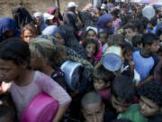 FILE - Palestinians line up for food distribution in Deir al-Balah, Gaza Strip, on Oct. 17, 2024.