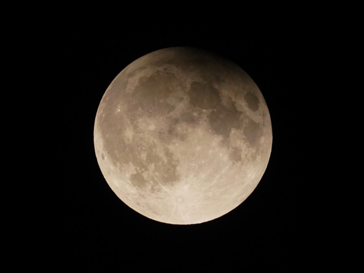 A supermoon with a partial lunar eclipse rises over Lake Michigan in Chicago on Sept. 17.