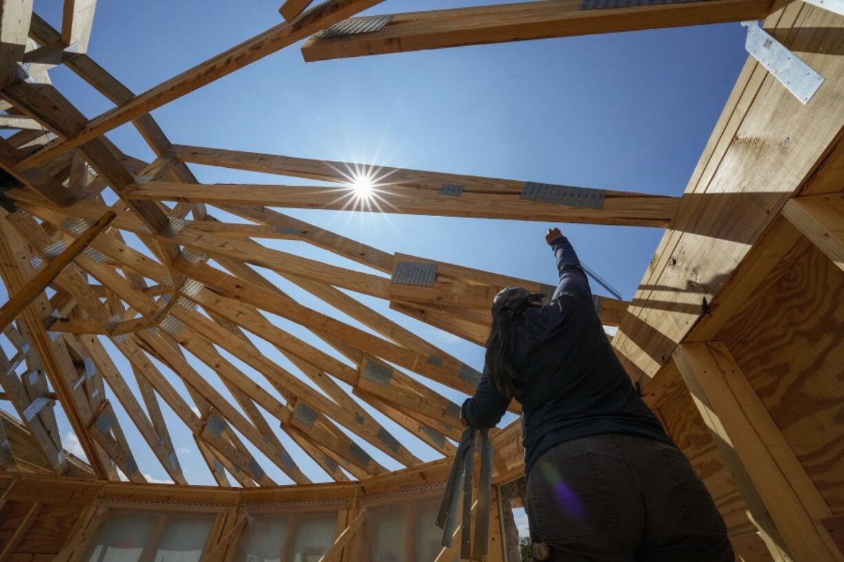 File - Workers build a home on Sept. 19, 2023, in Marshall, N.C.