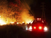 This photo provided by New Jersey Department of Environmental Protection firefighters respond to a forest fire on Wednesday, Nov. 6, 2024 in Evesham, N.J.