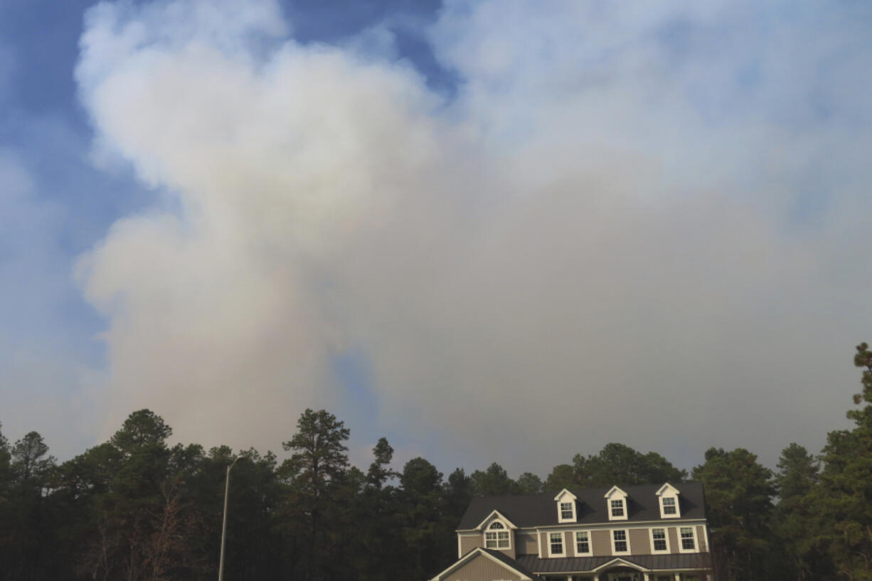 Smoke from a forest fire rises above the trees in Evesham,N.J. on Thursday, Nov. 7, 2024, when firefighters said conditions were the driest in New Jersey in nearly 120 years.