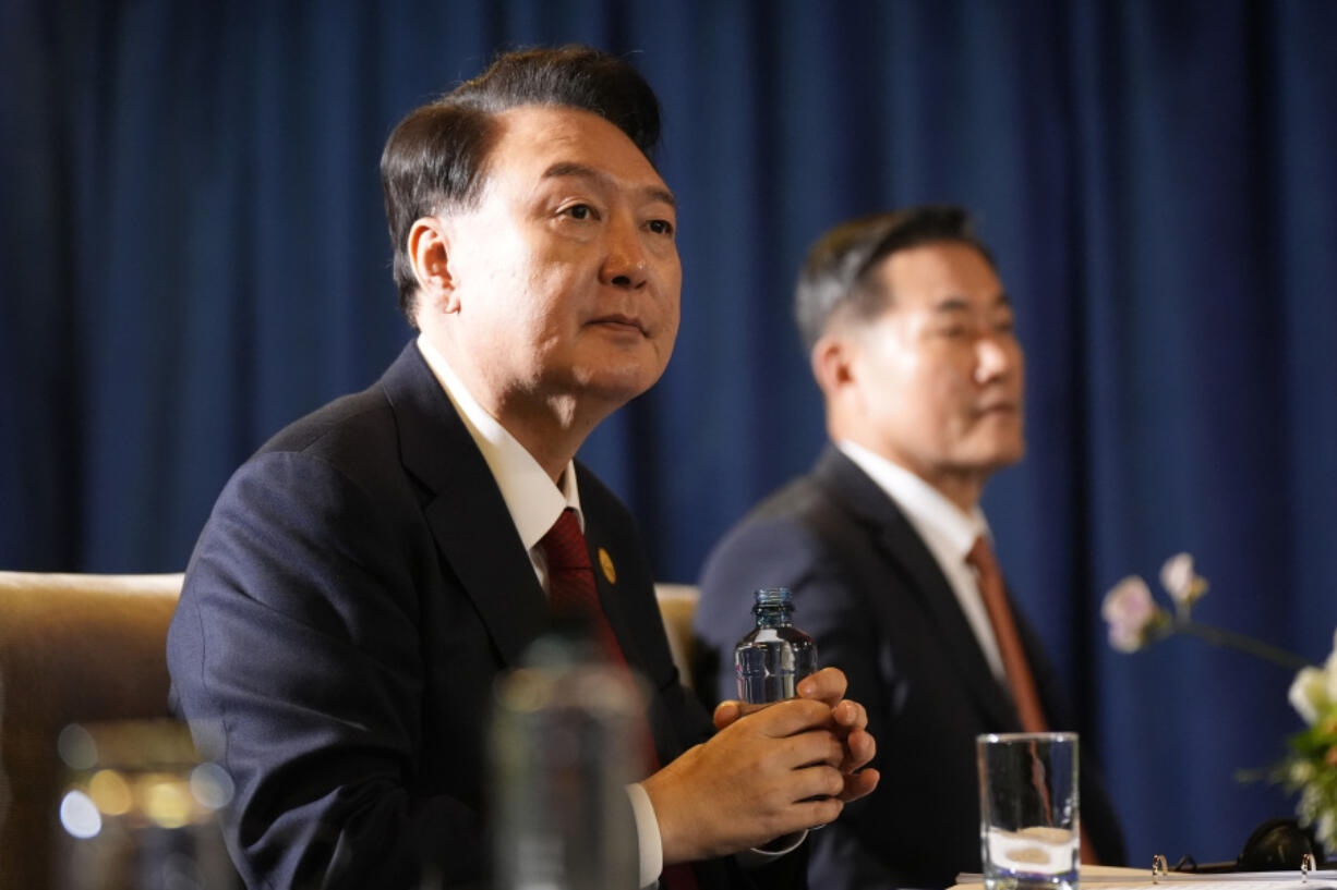 FILE - President of South Korea Yoon Suk Yeol, left, and National Security Director Shin Wonsik, right, listen during a trilateral meeting with President Joe Biden and the Prime Minister of Japan Shigeru Ishiba in Lima, Peru, Friday, Nov. 15, 2024.