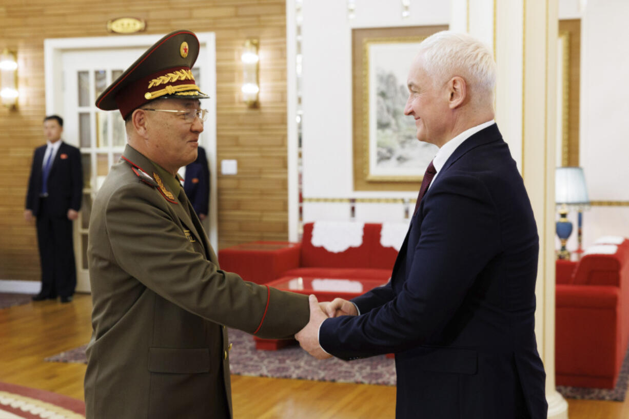 In this photo released by Russian Defense Ministry press service, North Korean Defense Minister No Kwang Chol, left, and Russian Defense Minister Andrei Belousov, right, shake hands during their meeting in Pyongyang, North Korea, Friday, Nov. 29, 2024.