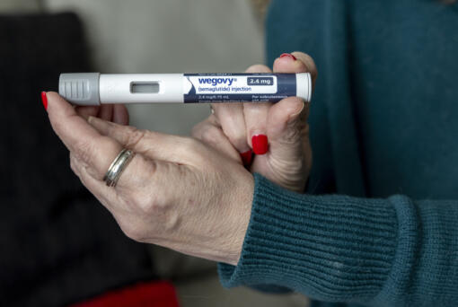 Donna Cooper holds up a dosage of Wegovy, a drug used for weight loss, at her home, March 1, 2024, in Front Royal, Va.