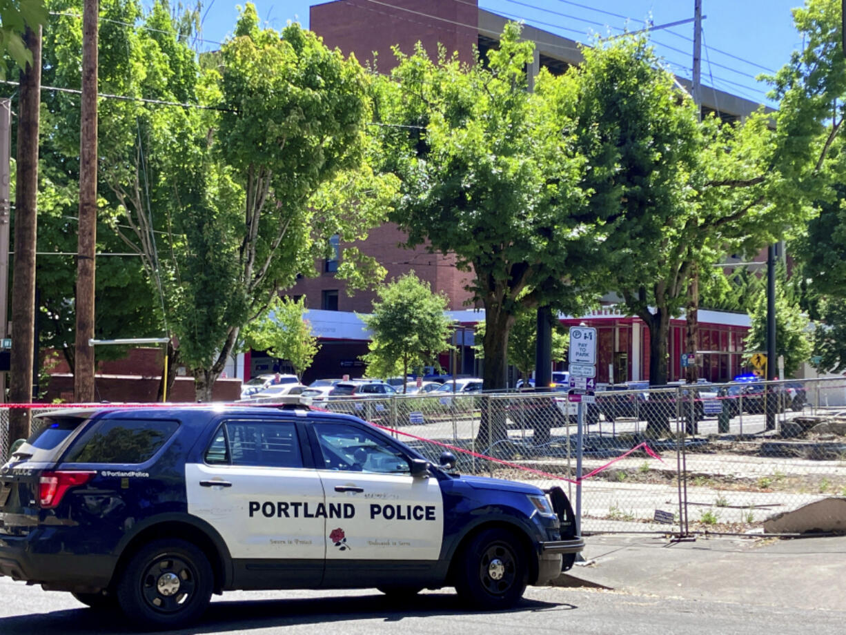 FILE - Portland Police respond to a shooting at the Legacy Good Samaritan Medical Center in Portland, Ore., July 22, 2023.