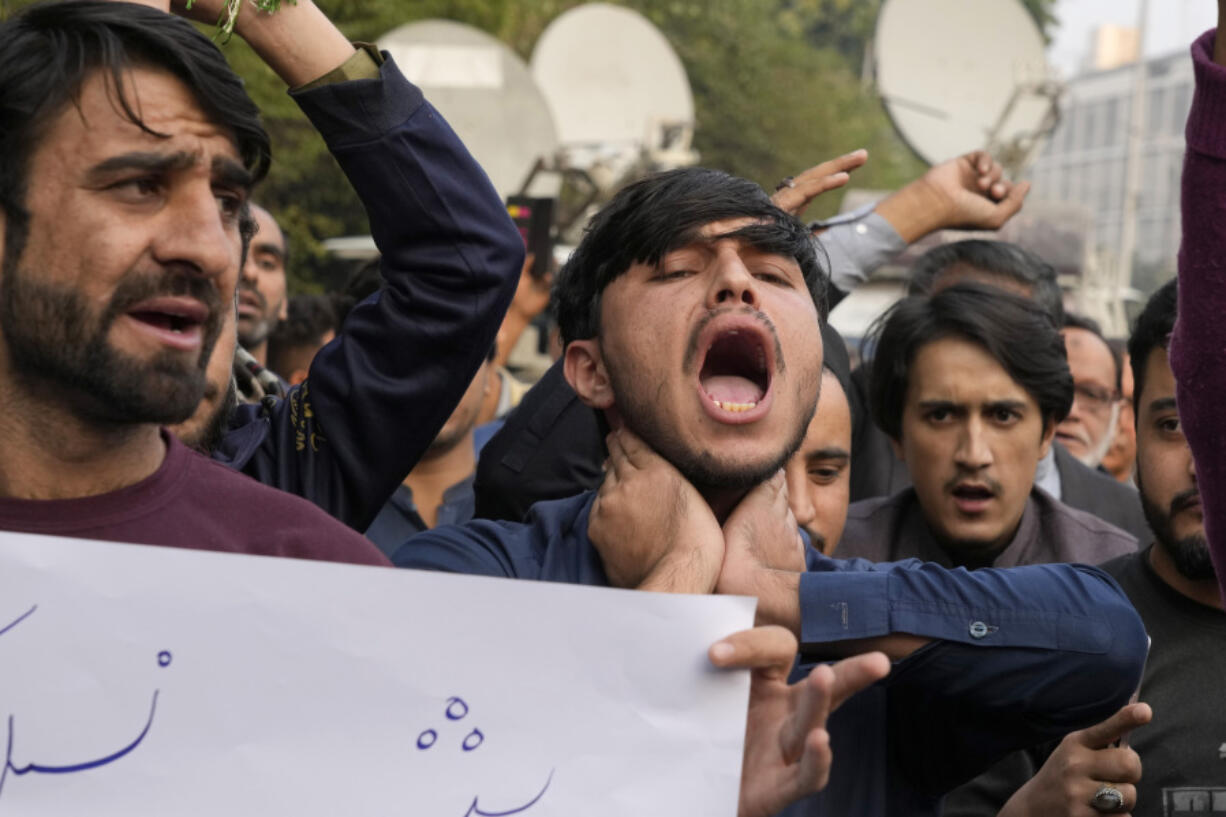 Shiite Muslims chant slogans to condemn the killing of Shiite Muslims by gunmen in an ambush in Kurram district, during a demonstration in Lahore, Pakistan, Friday, Nov. 22, 2024. (AP Photo/K.M.