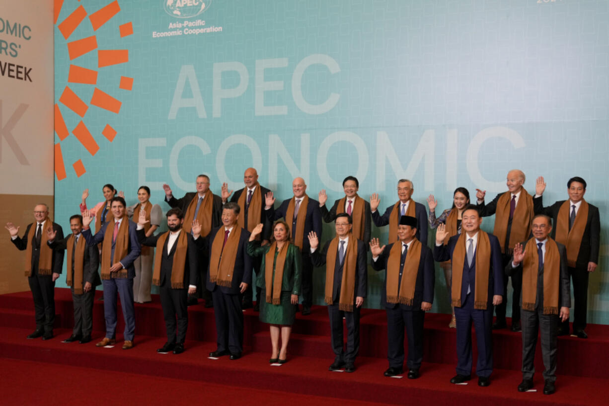 Leaders of the Asia-Pacific Economic Cooperation (APEC) pose for a group photo, in Lima, Peru, Saturday, Nov. 16, 2024.