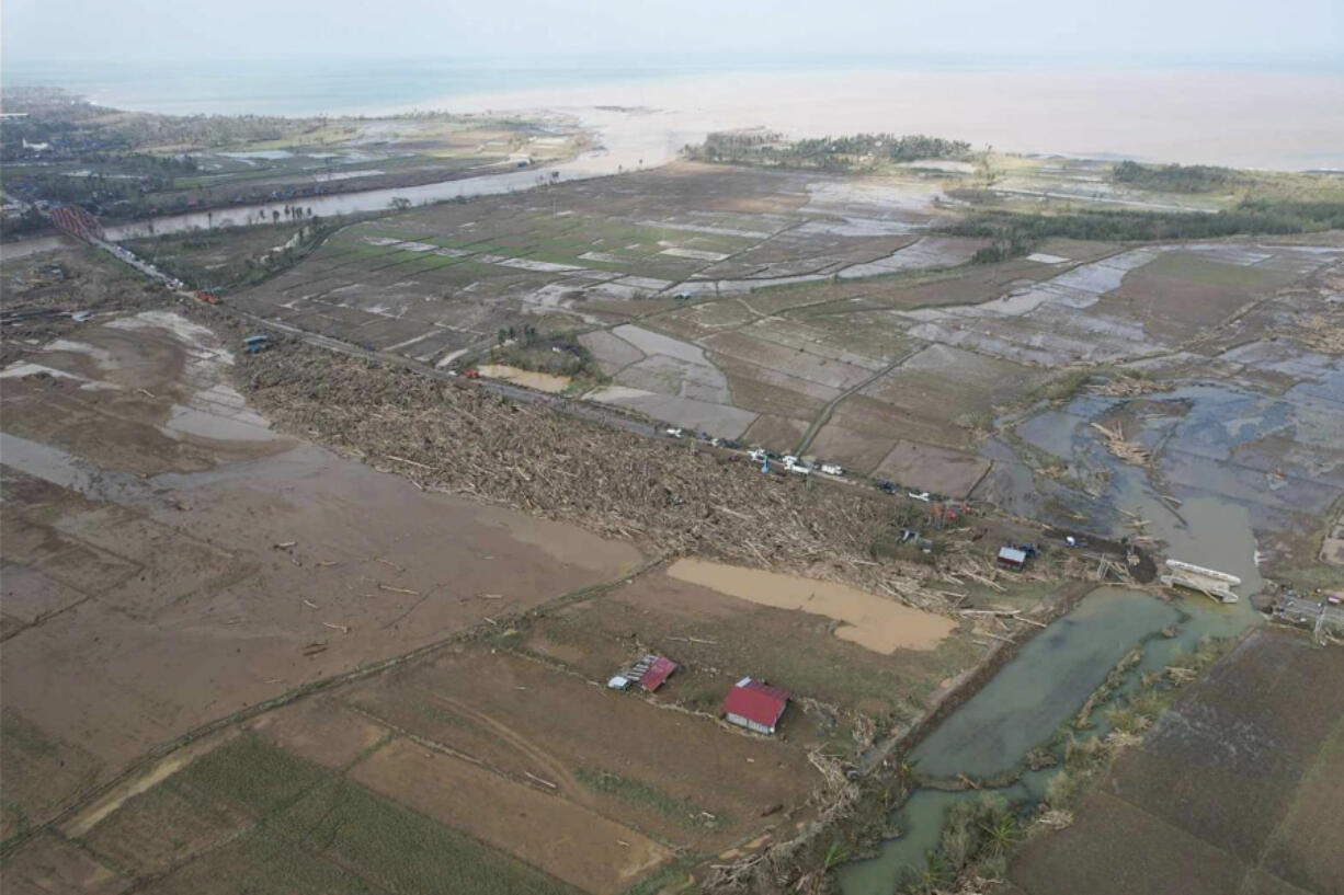 In this photo provided by the Philippine Red Cross, damaged trees and debris swept by floods lie near a broken bridge caused by Typhoon Usagi in Gonzaga, Cagayan province, northern Philippines on Friday, Nov. 15, 2024.