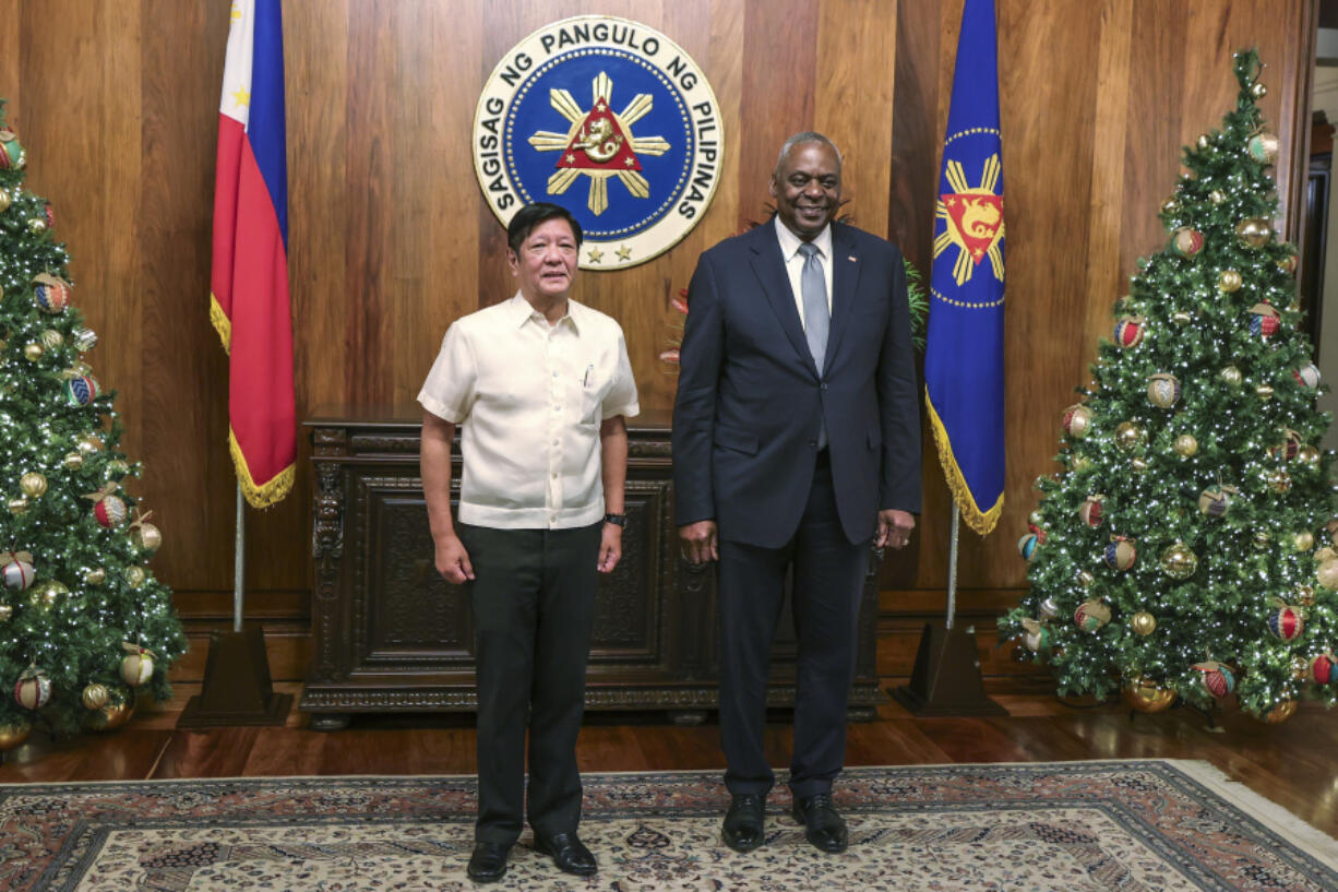 U.S. Defense Secretary Lloyd Austin, right, and Philippine President Ferdinand Marcos Jr. pose for a photograph during a courtesy call at the Malacanang Palace in Manila, Philippines Monday, Nov. 18, 2024.