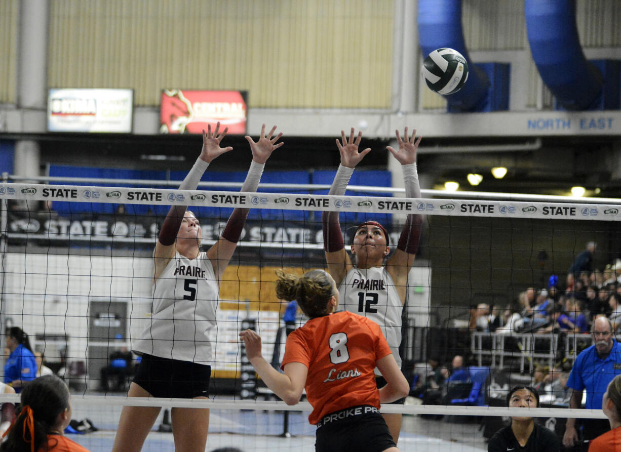 Prairie senior Claire Neuman (5) and sophomore Gracie Jacoby leap at the net during a round of 16 match against Kennewick in the Class 3A state volleyball tournament on Friday, Nov. 22, 2024 in Yakima.