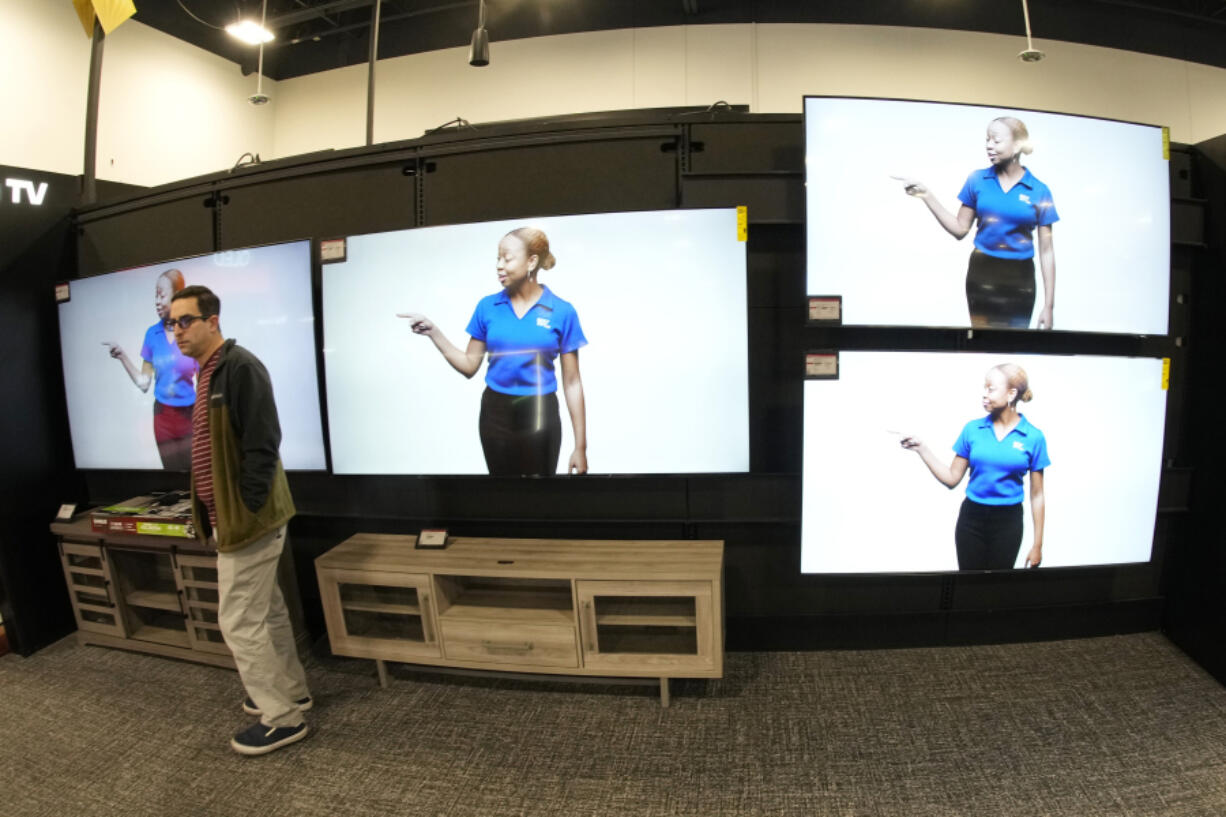 FILE - A customer turns away after looking at big-screen televisions in a Best Buy store Nov. 21, 2023, in southeast Denver.