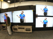 FILE - A customer turns away after looking at big-screen televisions in a Best Buy store Nov. 21, 2023, in southeast Denver.