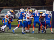 Ridgefield quarterback Landon DeBeaumont throws as pass against Fife in Saturday's 2A state preliminary game. Fife went on to win 34-7.