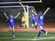 Ridgefield's Savvy Semlick (31) celebrates with teammates Tori Lasch (15) and Marlee Buffham (12) after scoring a goal against Bellingham during a Class 2A girls soccer state semifinal game on Friday, Nov. 22, 2024, at Mount Tahoma High School.