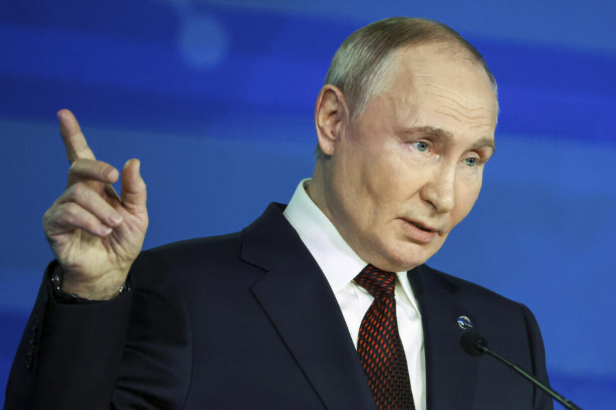 Russian President Vladimir Putin points during a meeting with foreign policy experts at the Valdai Discussion Club in the Black Sea resort of Sochi, Russia, Thursday, Nov. 7, 2024.