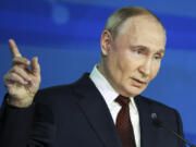 Russian President Vladimir Putin points during a meeting with foreign policy experts at the Valdai Discussion Club in the Black Sea resort of Sochi, Russia, Thursday, Nov. 7, 2024.