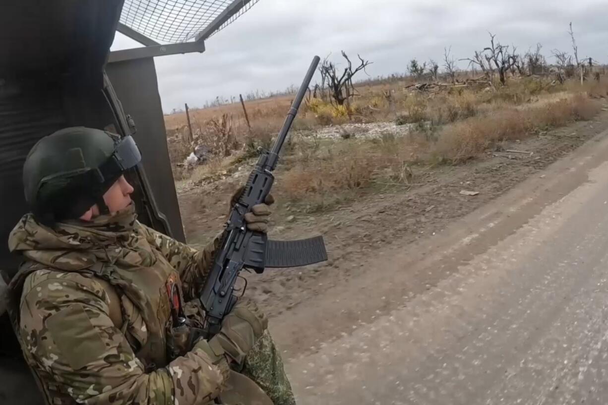 In this photo taken from a video released by Russian Defense Ministry Press Service on Friday, Nov. 22, 2024, a Russian engineer troops serviceman operates at an undisclosed location in Ukraine.