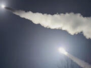 This image was made from a video posted by a Telegram channel affiliated with the Ukrainian military on Tuesday, Nov. 19, 2024. The channel says it shows U.S.-supplied ATACMS missiles being fired from an undisclosed location in Ukraine. The Associated Press cannot independently verify the date and location the video was filmed.