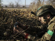 In this photo provided by Ukraine&rsquo;s 24th Mechanised Brigade press service, a serviceman of the 24th Mechanised Brigade installs landmines and non explosive obstacles along the front line near Chasiv Yar town in Donetsk region, Ukraine, Wednesday Oct. 30, 2024.