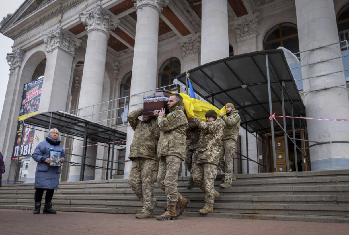 Fellow soldiers carry a coffin of leading actor Petro Velykiy, 48, who was killed in a battle with the Russian troops in Russia&rsquo;s Kursk region, during farewell ceremony in the music and drama theatre in Chernyhiv, Ukraine, Wednesday, Nov.