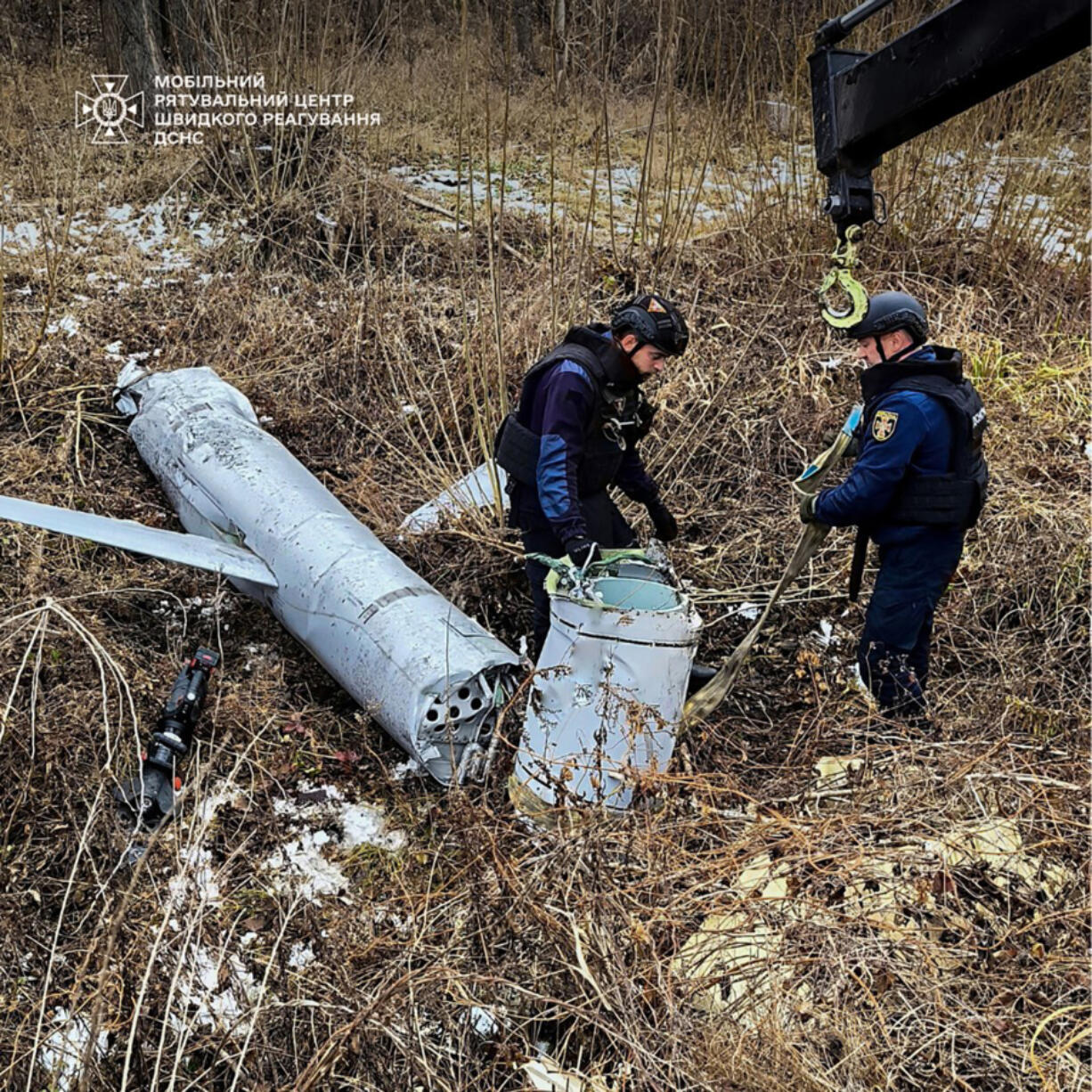 In this photo provided by the Ukrainian Emergency Service, pyrotechnists examine an X-55 Russian aviation cruise missile that was shot down in Kyiv, Ukraine, Thursday, Nov. 28, 2024.