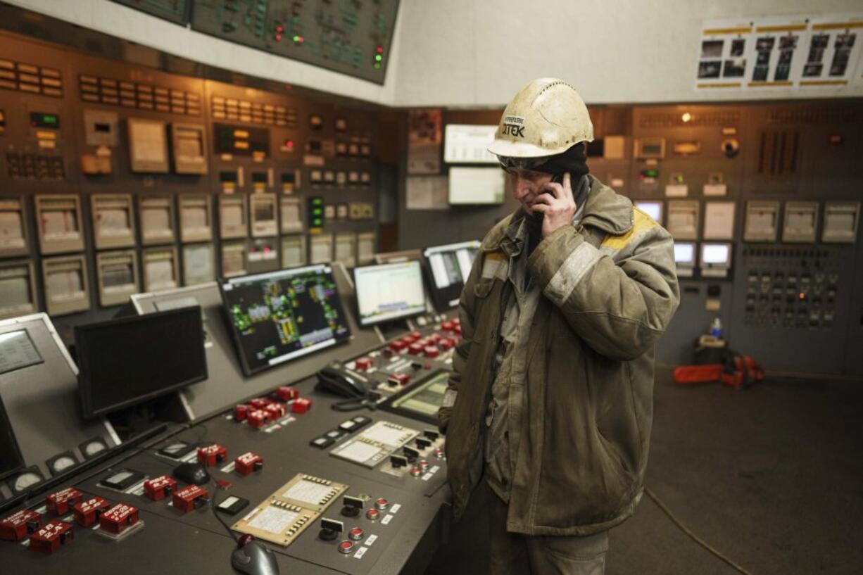 A worker speaks by mobile phone inside operating room at DTEK&rsquo;s power plant after a recent Russian missile attack in Ukraine, Nov. 28, 2024.