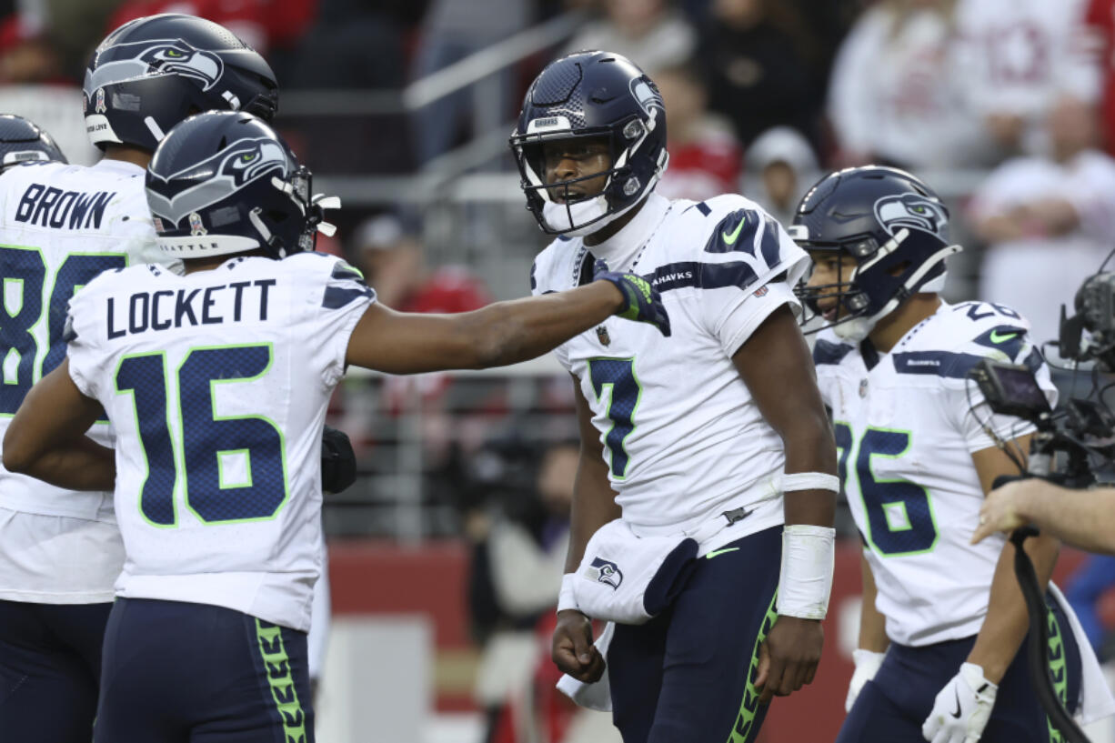 Seahawks quarterback Geno Smith (7) celebrates with Tyler Lockett (16) after scoring against the San Francisco 49ers in last Sunday&rsquo;s 20-17 win.football game in Santa Clara, Calif., Sunday, Nov. 17, 2024.