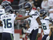 Seahawks quarterback Geno Smith (7) celebrates with Tyler Lockett (16) after scoring against the San Francisco 49ers in last Sunday&rsquo;s 20-17 win.football game in Santa Clara, Calif., Sunday, Nov. 17, 2024.