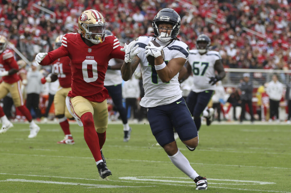 Seattle Seahawks wide receiver Jaxon Smith-Njigba, foreground right, runs against San Francisco 49ers cornerback Renardo Green (0) during the second half of an NFL football game in Santa Clara, Calif., Sunday, Nov. 17, 2024.