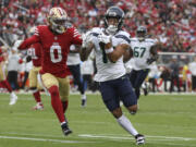 Seattle Seahawks wide receiver Jaxon Smith-Njigba, foreground right, runs against San Francisco 49ers cornerback Renardo Green (0) during the second half of an NFL football game in Santa Clara, Calif., Sunday, Nov. 17, 2024.