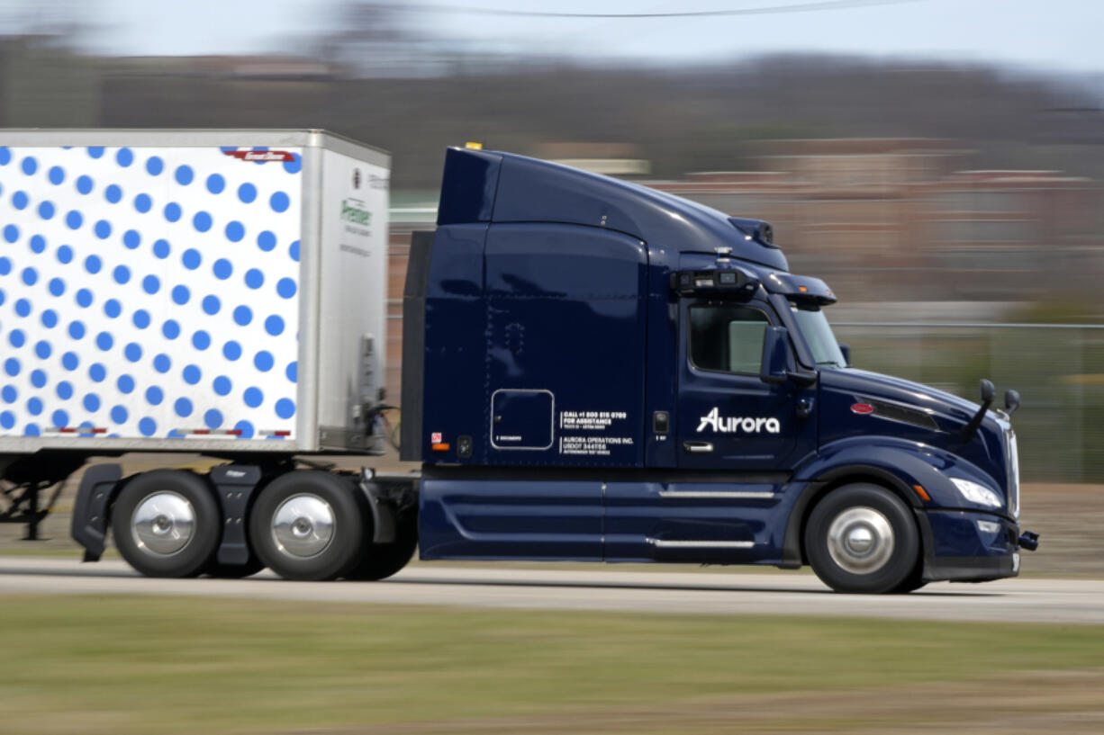 FILE - A self-driving tractor trailer maneuvers around a test track in Pittsburgh, Thursday, March 14, 2024. The truck is owned by Pittsburgh-based Aurora Innovation Inc. (AP Photo/Gene J.