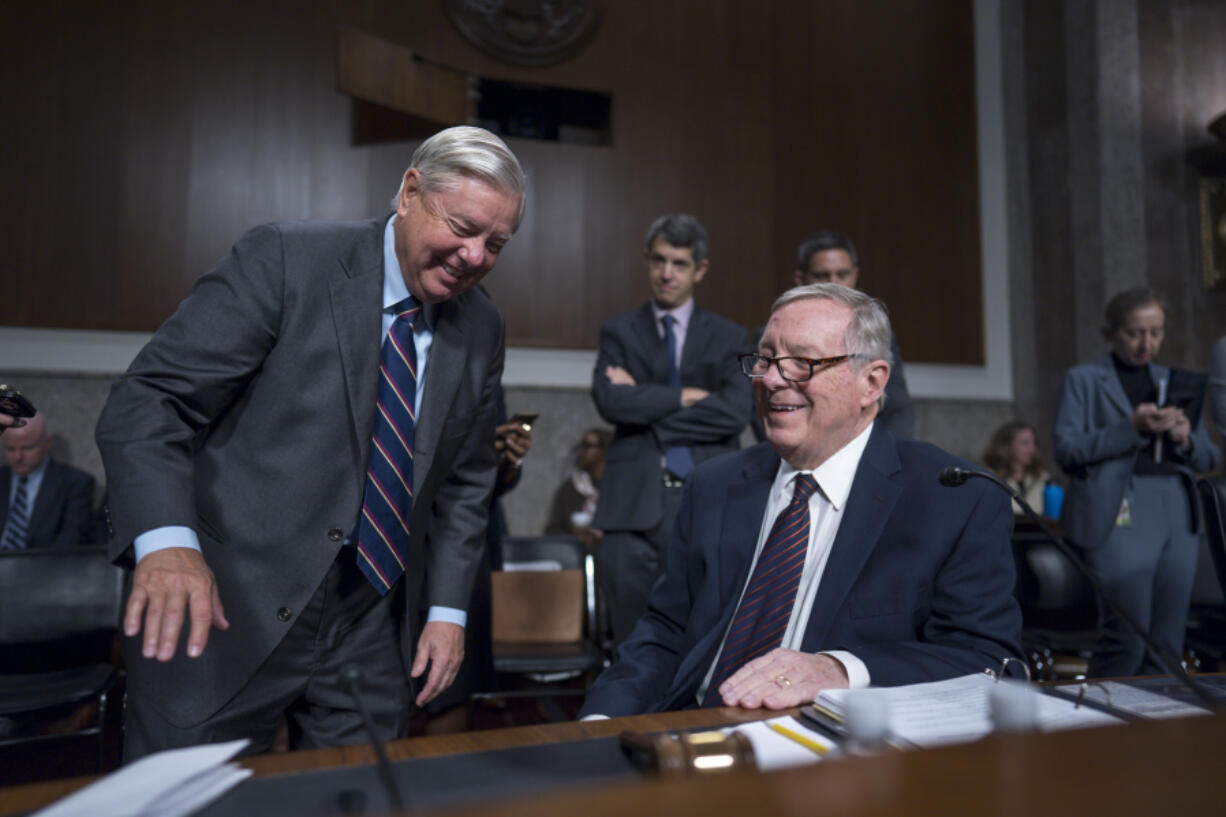 Senate Judiciary Committee Chairman Dick Durbin, D-Ill., seated at right, confers with Sen. Lindsey Graham, R-S.C., left, the ranking member, as the panel convenes to confirm President Joe Biden&rsquo;s nominees in the closing weeks of the 118th Congress and before Donald Trump takes office, at the Capitol in Washington, Thursday, Nov. 14, 2024. (AP Photo/J.