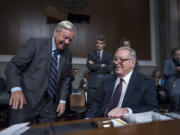 Senate Judiciary Committee Chairman Dick Durbin, D-Ill., seated at right, confers with Sen. Lindsey Graham, R-S.C., left, the ranking member, as the panel convenes to confirm President Joe Biden&rsquo;s nominees in the closing weeks of the 118th Congress and before Donald Trump takes office, at the Capitol in Washington, Thursday, Nov. 14, 2024. (AP Photo/J.