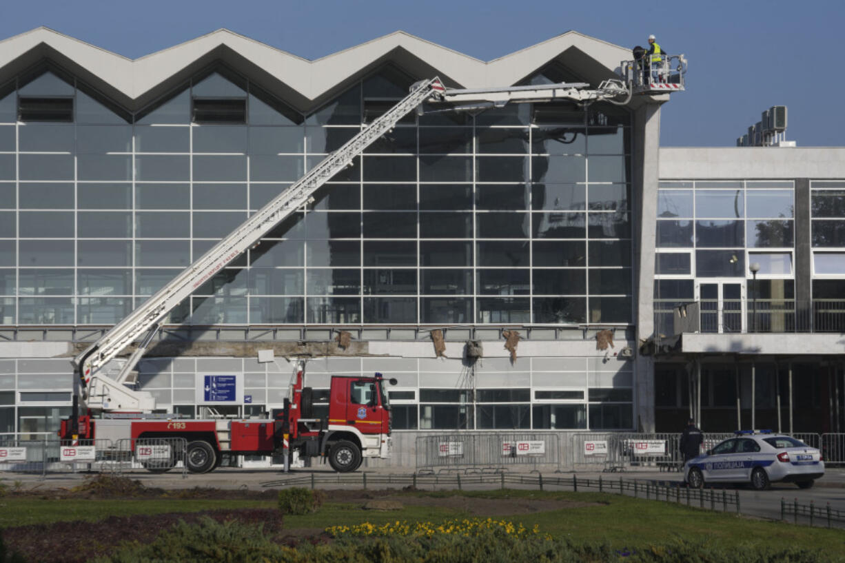 Workers inspect a train station after an outdoor roof collapsed o Friday,  in Novi Sad, Serbia, Saturday, Nov. 2, 2024.