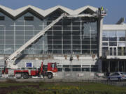 Workers inspect a train station after an outdoor roof collapsed o Friday,  in Novi Sad, Serbia, Saturday, Nov. 2, 2024.