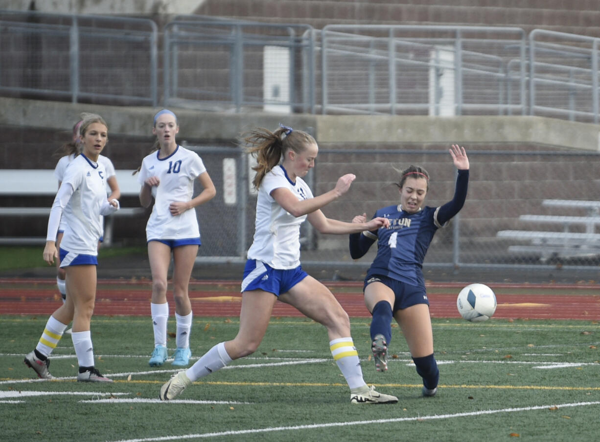 Seton Catholic's CJ Moore (4) attempts a shot as she draws contact against Bellevue Christian's Charlotte Aitken (11) during a Class 1A girls soccer state semifinal game on Friday, Nov. 22, 2024, at Mount Tahoma High School.