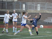 Seton Catholic's CJ Moore (4) attempts a shot as she draws contact against Bellevue Christian's Charlotte Aitken (11) during a Class 1A girls soccer state semifinal game on Friday, Nov. 22, 2024, at Mount Tahoma High School.