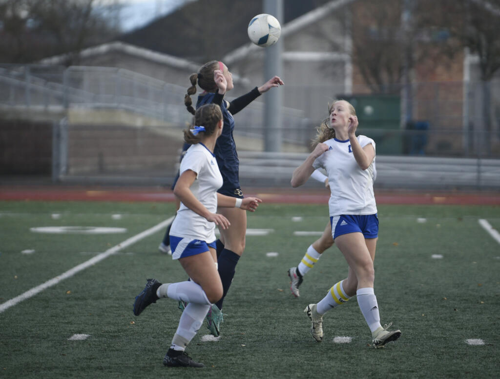 Seton Catholic's Hailey Herboth, left, looks to head the ball against multiple Bellevue Christian defenders during a Class 1A girls soccer state semifinal game on Friday, Nov. 22, 2024, at Mount Tahoma High School.