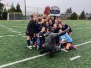 Seton Catholic players and coach Antonio Buckley pose for a photo after the Cougars' 1-0 win over The Bush School in the Class 1A girls soccer state quarterfinals on Saturday, Nov. 16, 2024, at Seton Catholic High School.