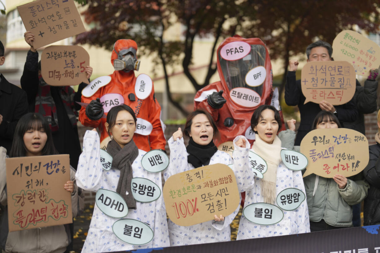 Environment activists shout slogans during a rally calling for a strong global plastics treaty ahead of the fifth session of the Intergovernmental Negotiating Committee on Plastic Pollution which sets to be held in Busan from Nov. 25 to Dec. 1, in Seoul, South Korea, Wednesday.