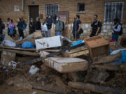 Residents wait for public transportation in an area, affected by floods, in Paiporta, Valencia, Spain, Tuesday, Nov. 5, 2024.