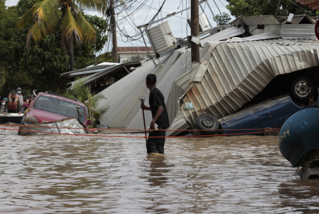 A resident examines storm damage caused by Hurricane Eta in Planeta, Honduras, on Nov. 6, 2020.