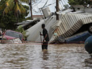 A resident examines storm damage caused by Hurricane Eta in Planeta, Honduras, on Nov. 6, 2020.