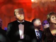 President-elect Donald Trump listens with Linda McMahon during an America First Policy Institute gala at his Mar-a-Lago estate, Thursday, Nov. 14, 2024, in Palm Beach, Fla.