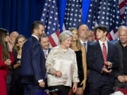 From left, Kimberly Guilfoyle, Tony Fabriozio, Donald Trump Jr., fourth from left, Justin Caporale, Susie Wiles, Kai Madison Trump, Dan Scavino, Corey Lewandowski, Donald Trump III and Dana White listen as Republican presidential nominee former President Donald Trump speaks at an election night watch party Wednesday, Nov. 6, 2024, in West Palm Beach, Fla.