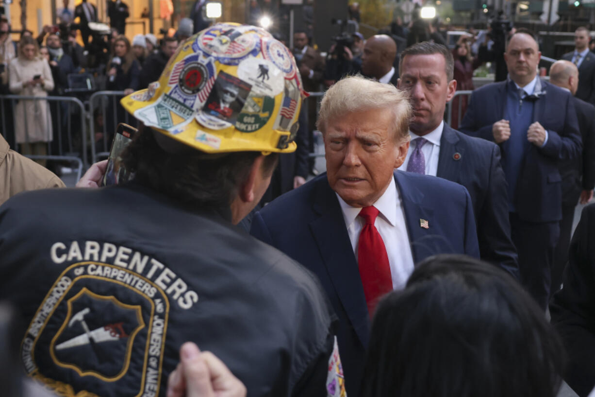 FILE - Former President Donald Trump speaks with construction workers in midtown Manhattan, April 25, 2024, in New York.