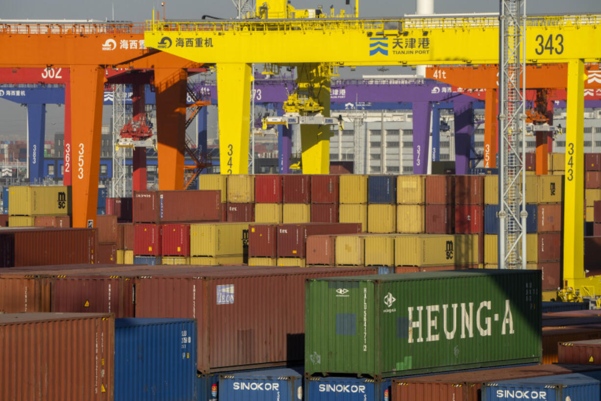 FILE - Shipping containers are stacked at a port in Tianjin, China, Jan. 16, 2023.