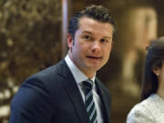 FILE - Pete Hegseth walks to an elevator for a meeting with President-elect Donald Trump at Trump Tower in New York, Dec. 15, 2016.