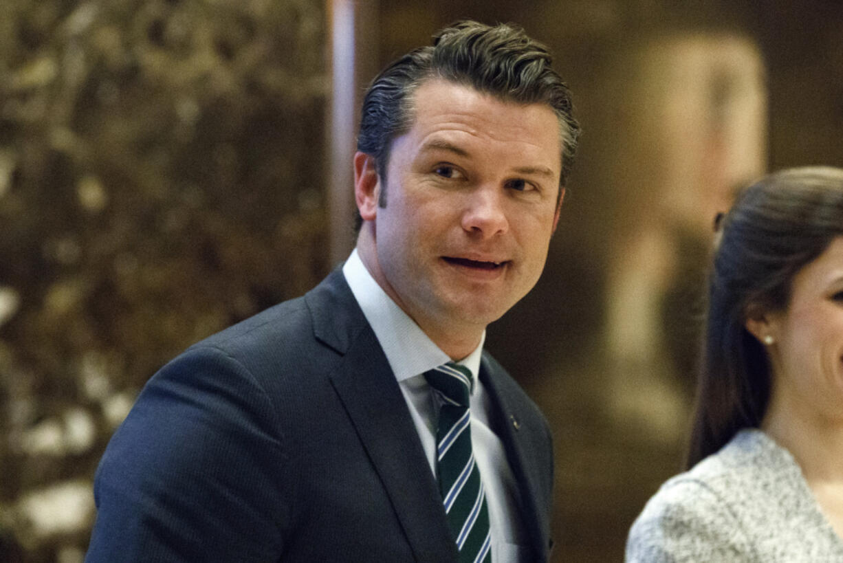 FILE - Pete Hegseth walks to an elevator for a meeting with President-elect Donald Trump at Trump Tower in New York, Dec. 15, 2016.